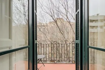 an open window with a view of a balcony at Novus Homes Barcelona Eixample in Barcelona