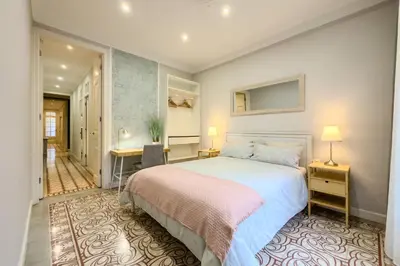 a bedroom with a large bed and a hallway at Novus Homes Barcelona Eixample in Barcelona