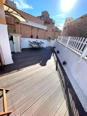a rooftop deck with a picnic table on a building at Plaza de España independent house in Barcelona