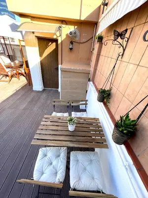 a porch with a wooden bench on a deck at Plaza de España independent house in Barcelona