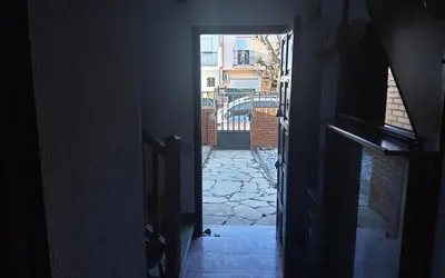 an open door to a hallway with a stone walkway at Holidays Domus Iano in Esparreguera