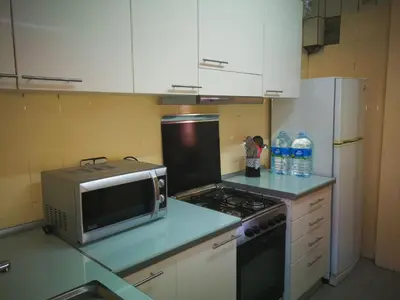 a kitchen with a microwave and a stove top oven at Holidays Domus Iano in Esparreguera