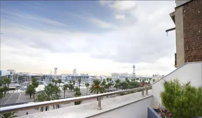 a view of the harbor from the balcony of a building at Ola Living Merce in Barcelona