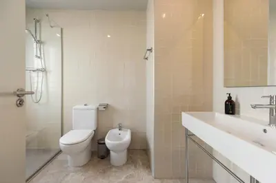 a bathroom with a toilet and a sink and a shower at Ola Living Merce in Barcelona