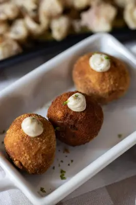 three muffins with sour cream on a white plate at Camping El Pasqualet in Caldes de Montbui