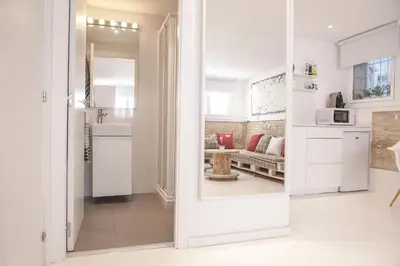 a kitchen with a door leading to a living room at Studio Relax by Hello Homes Sitges in Sitges