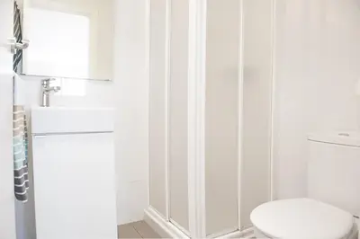 a white bathroom with a toilet and a shower at Studio Relax by Hello Homes Sitges in Sitges