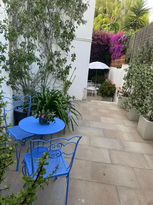 a patio with two tables and chairs and plants at Studio Relax by Hello Homes Sitges in Sitges