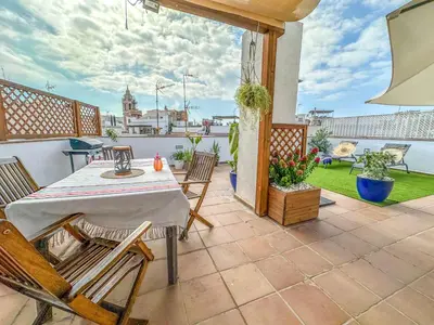 a patio with a table and chairs on a balcony at Sanctuary Penthouse by Hello Homes Sitges in Sitges