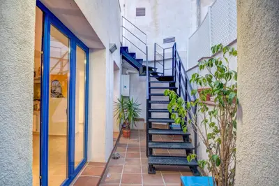 a hallway with blue stairs in a building at Sanctuary Penthouse by Hello Homes Sitges in Sitges