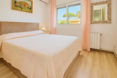 a bedroom with a white bed and a window at Next to the sea 20' from Barcelona in Premiá de Mar