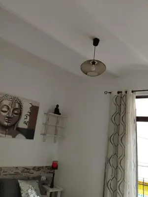 a bedroom with a ceiling fan and a bed at Apartment Fira Bcn Camp Nou in Hospitalet de Llobregat