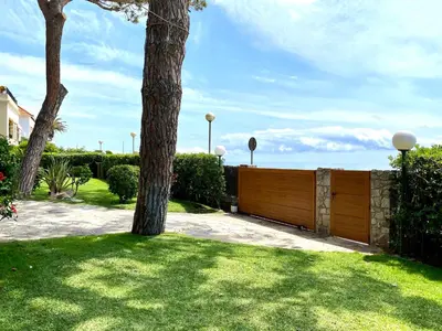 a wooden fence in a yard with a tree at Musclera in Arenys de Mar