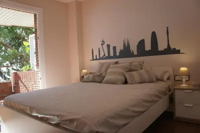 a bedroom with a bed with a skyline of cities on the wall at Musclera in Arenys de Mar
