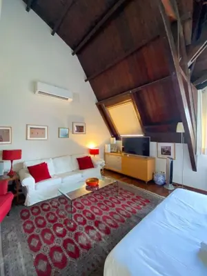 a living room with a bed and a couch at Passeig de Gracia Studio Loft in Barcelona