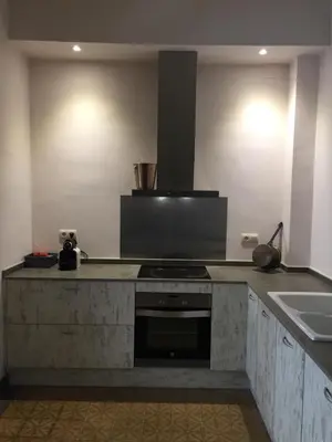 a kitchen with a stove and a sink at Piso Vilanova i la Geltrú in Vilanova i la Geltrú