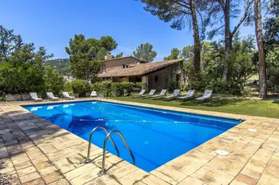 a swimming pool with chairs and a house at Catalunya Casas Heavenly Haven for 16 pax , 30km from Barcelona! in Castellar