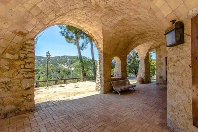 a stone archway with a bench in a building at Catalunya Casas Heavenly Haven for 16 pax , 30km from Barcelona! in Castellar