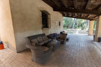 a living room with couches and chairs on a patio at Catalunya Casas Heavenly Haven for 16 pax , 30km from Barcelona! in Castellar