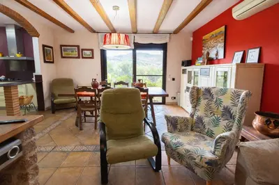 a living room with a table and a chair at Catalunya Casas Peaceful Perfection , only 30km from Barcelona! in Vacarisas