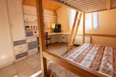 a bedroom with a bunk bed and a desk at Catalunya Casas Peaceful Perfection , only 30km from Barcelona! in Vacarisas