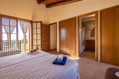 a bedroom with a bed with a blue towel on it at Catalunya Casas Nature and Tranquility for 24 pax - 30km to beach in Sant Pere de Vilamajor