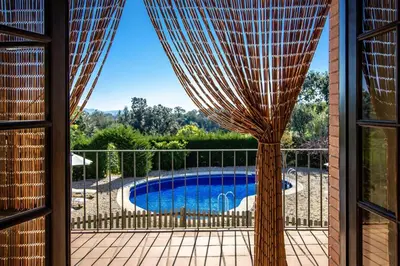 a view of a pool from a window at Catalunya Casas Nature and Tranquility for 24 pax - 30km to beach in Sant Pere de Vilamajor