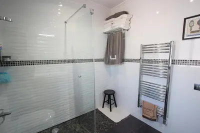 a bathroom with a shower with a glass door at Catalunya Casas Mountain escape with amazing views just 25km to BCN! in Torrelles de Llobregat