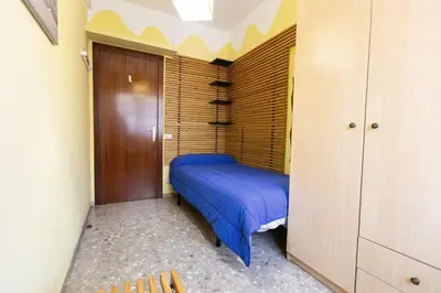 a small bedroom with a blue bed in a room at David's House in Barcelona