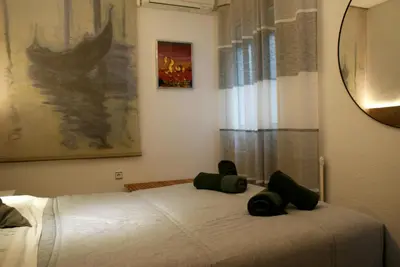 a bedroom with a white bed with green pillows on it at David's House in Barcelona