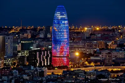 a lit up tower in a city at night at David's House in Barcelona