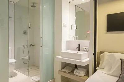 a bathroom with a sink and a shower at Hotel Denit Barcelona in Barcelona