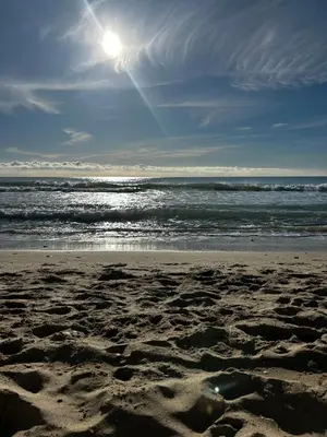 a sandy beach with the ocean in the background at Apartment Foix in Cubelles