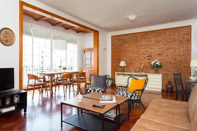 a living room with a couch and a table at Casa Cosi Mallorca I in Barcelona