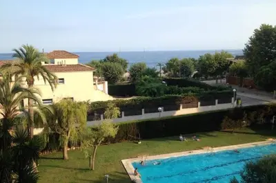 a view of a house and a swimming pool at The Hollidays Apartment in Calella