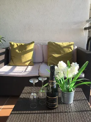 a bottle of wine and two glasses on a table at The Hollidays Apartment in Calella