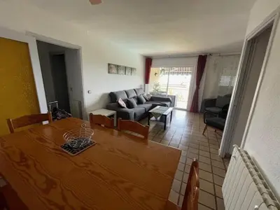 a living room with a table and a couch at The Hollidays Apartment in Calella
