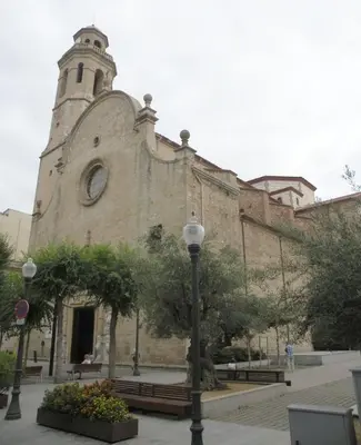 an old building with a clock tower and a street light at The Hollidays Apartment in Calella