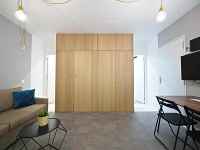 a living room with a couch and a wooden cabinet at Torrassa Cozy Apartment by Olala Homes in Hospitalet de Llobregat