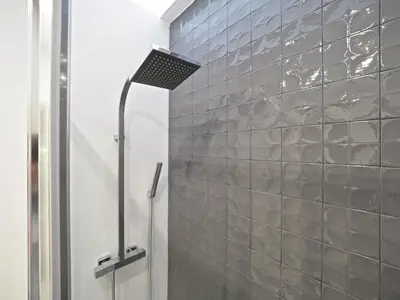 a shower in a bathroom with a tile wall at Torrassa Cozy Apartment by Olala Homes in Hospitalet de Llobregat