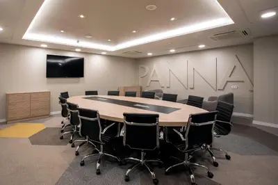 a conference room with tables and chairs and a large screen at Golden Hotel Barcelona in Barcelona