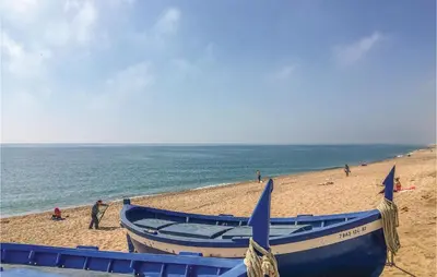 two boats sitting on a beach next to the ocean at Lovely Apartment In Pineda De Mar in Pineda de Mar