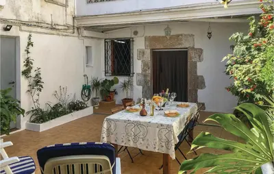 a table with a white table cloth on a patio at Lovely Apartment In Pineda De Mar in Pineda de Mar
