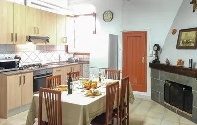 a kitchen with a table with fruit on it at Lovely Apartment In Pineda De Mar in Pineda de Mar