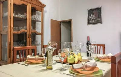 a table with wine glasses and a bottle of wine at Lovely Apartment In Pineda De Mar in Pineda de Mar