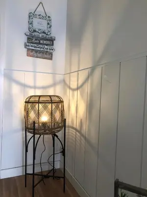 a wicker chair sitting next to a wall with a sign at Vilasardemarlux1 in Vilassar de Mar