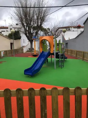 a playground with a blue slide on a green field at Vilasardemarlux1 in Vilassar de Mar