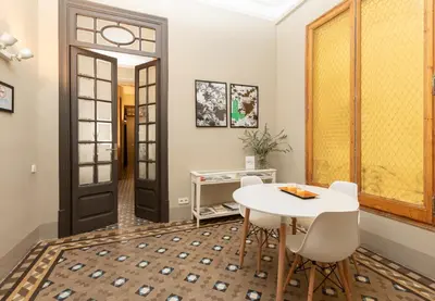 a dining room with a white table and white chairs at CasaNova Guest House in Barcelona