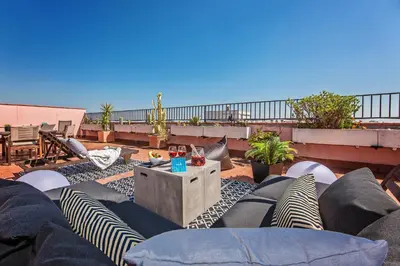 a patio with chairs and a table on a roof at Sweett - Pedrera Department 24 in Barcelona