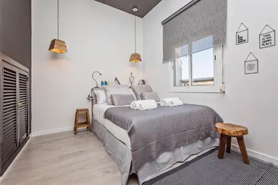 a bedroom with a bed with two towels on it at Sweett - Pedrera Department 24 in Barcelona